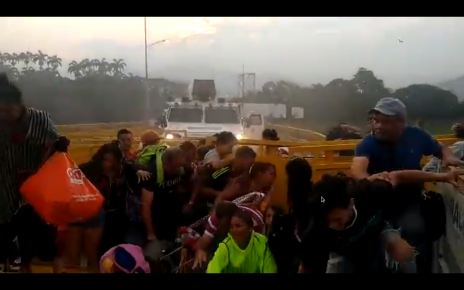 WATCH: Desperate times in #Venezuela  – Venezuelan people jumping the barricades to flee to Colombia!